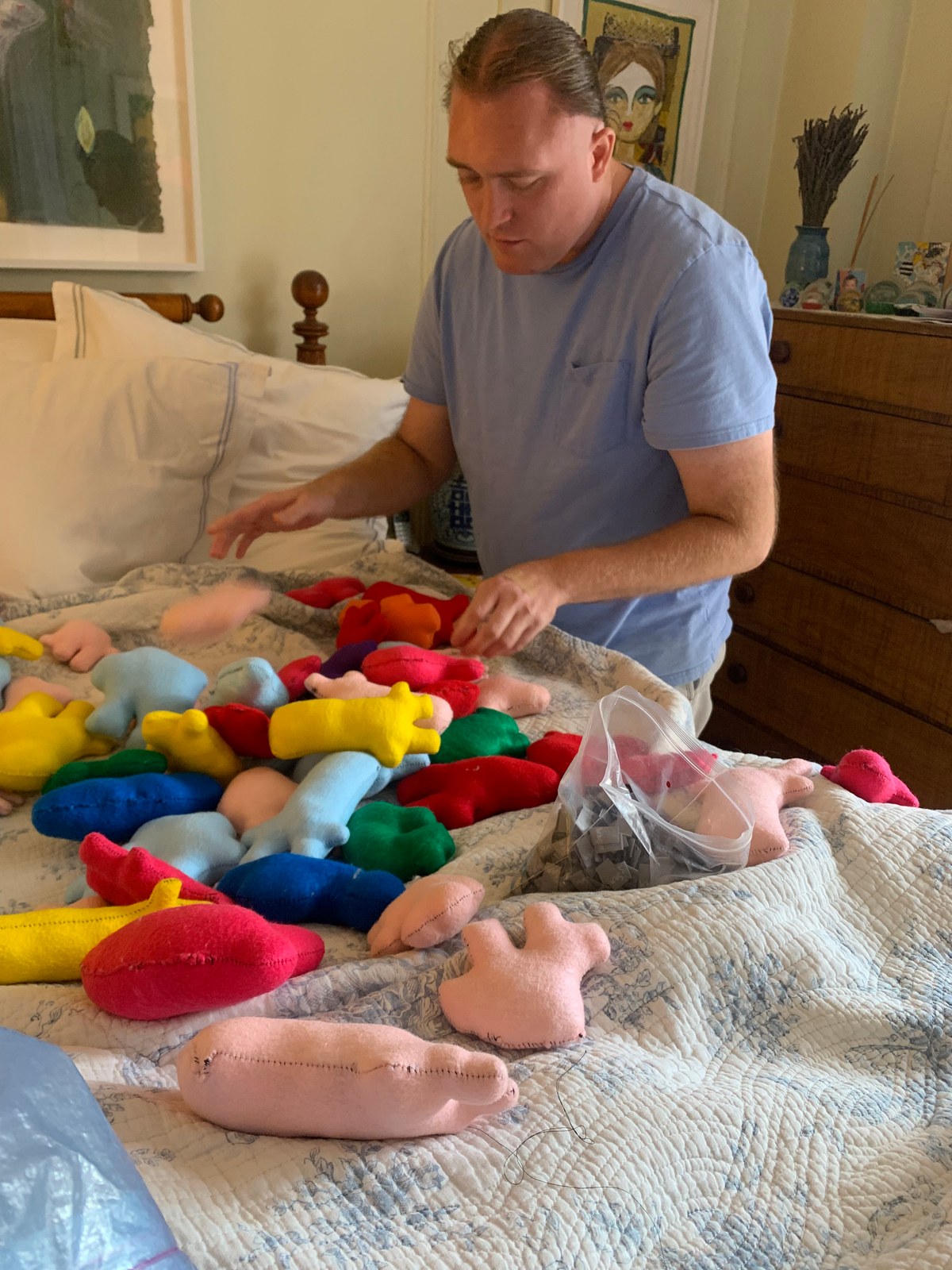 Sam at work with dolls, yarn, and buttons